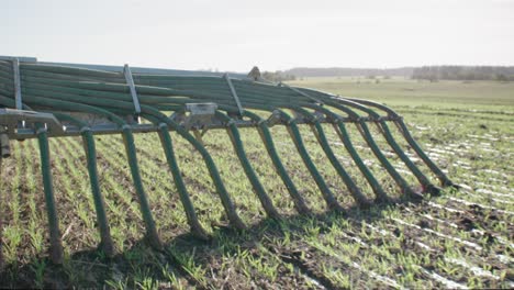 liquid manure spreader releasing slurry on field