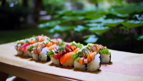 assorted sushi platter in an outdoor garden setting