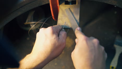 jeweler grinds gold on stand at workplace close upper view