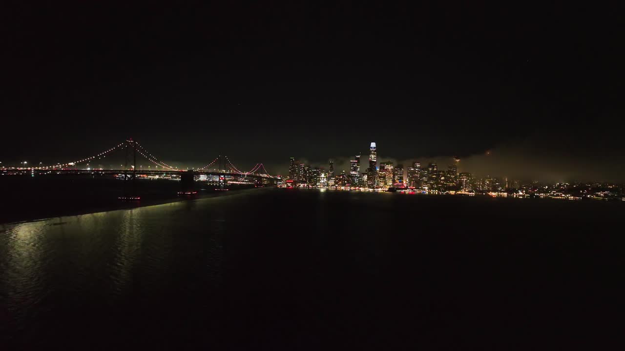 Aerial view approaching the skyline of San Francisco, foggy night in USA