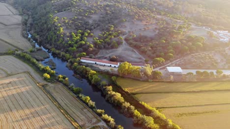 drone shot of a creek in a farming landscape in alentejo