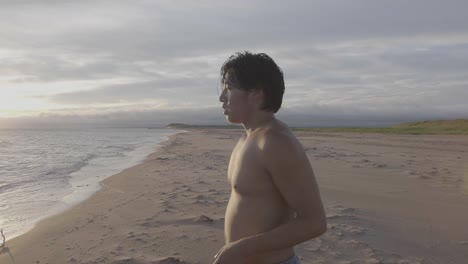 Dancer-on-beach-looking-off-into-distance