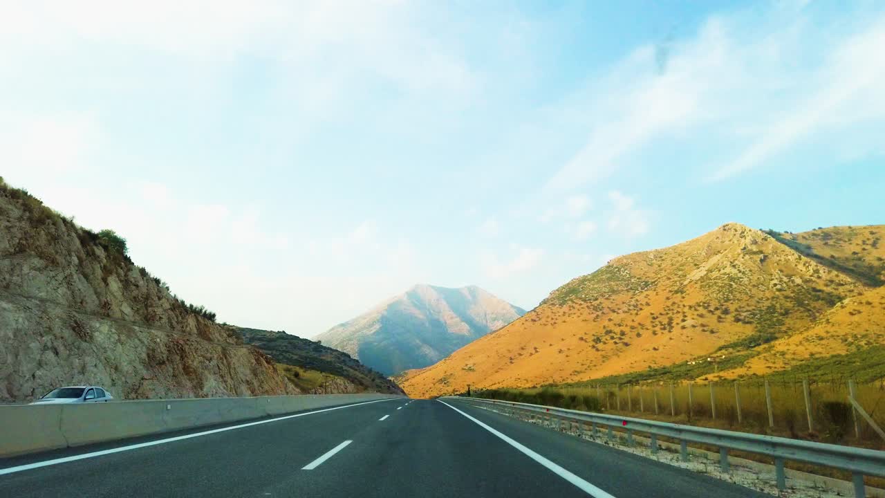Car driving by buildings on autobahn, first person view