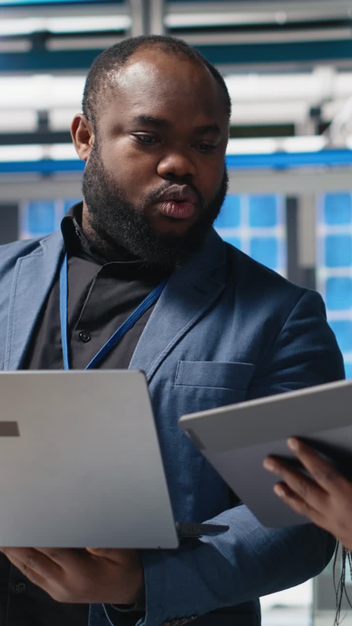 Vertical Video African american engineers team collaborating in a solar panel facility