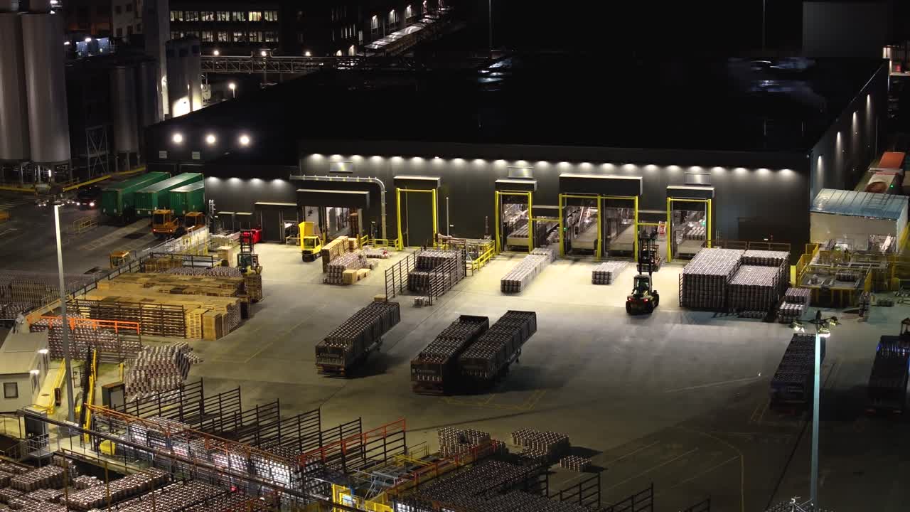 4K cinematic drone footage of the Guinness Factory exterior in Dublin, highlighting warehouse logistics, trucks, forklifts in motion, and the bustling industrial atmosphere._041