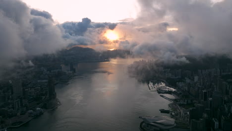 beautiful sunrise between clouds over victoria harbour, hong kong, epic cinematic wide establishing shot