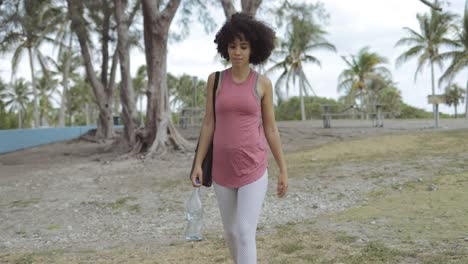 relaxed girl with water and yoga mat