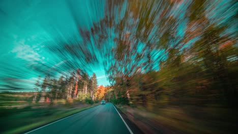 A-narrow-asphalt-road-winding-through-the-forest-in-the-Krivoklatsko,-Czechia