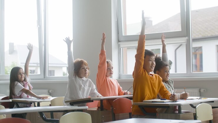 Students raising hands up.
