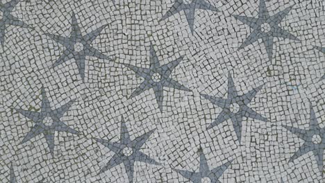 aerial top view of the mosaic floor showing the historical stars in chapel square, lisbon, portugal