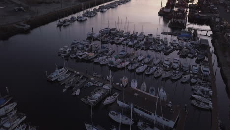 breathtaking sunset over the yacht club and marina in san pedro, los angeles, california, aerial drone tilt down shot