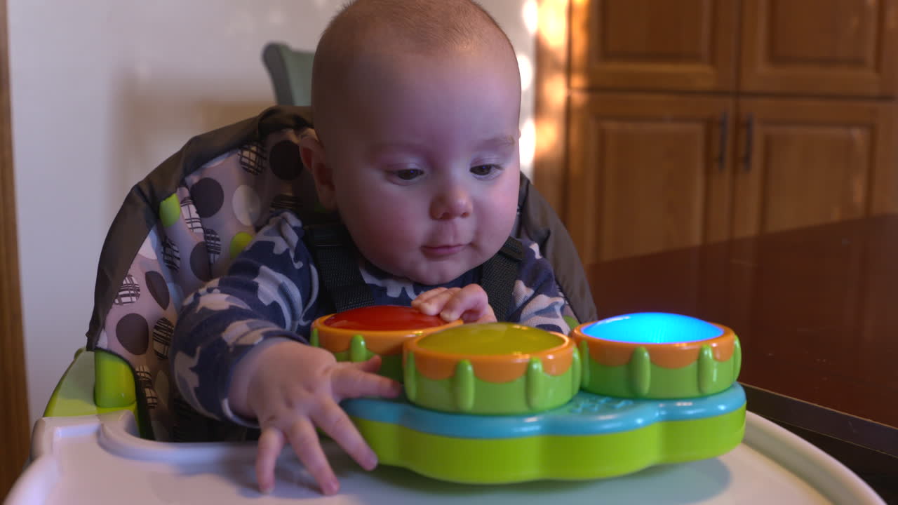 Cute baby boy playing with a flashing toy