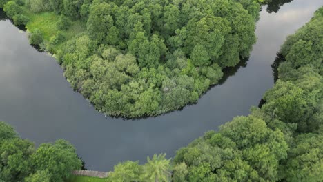 Drone-recording-of-Gudenå,-where-the-drone-reverses-slowly-across-the-stream