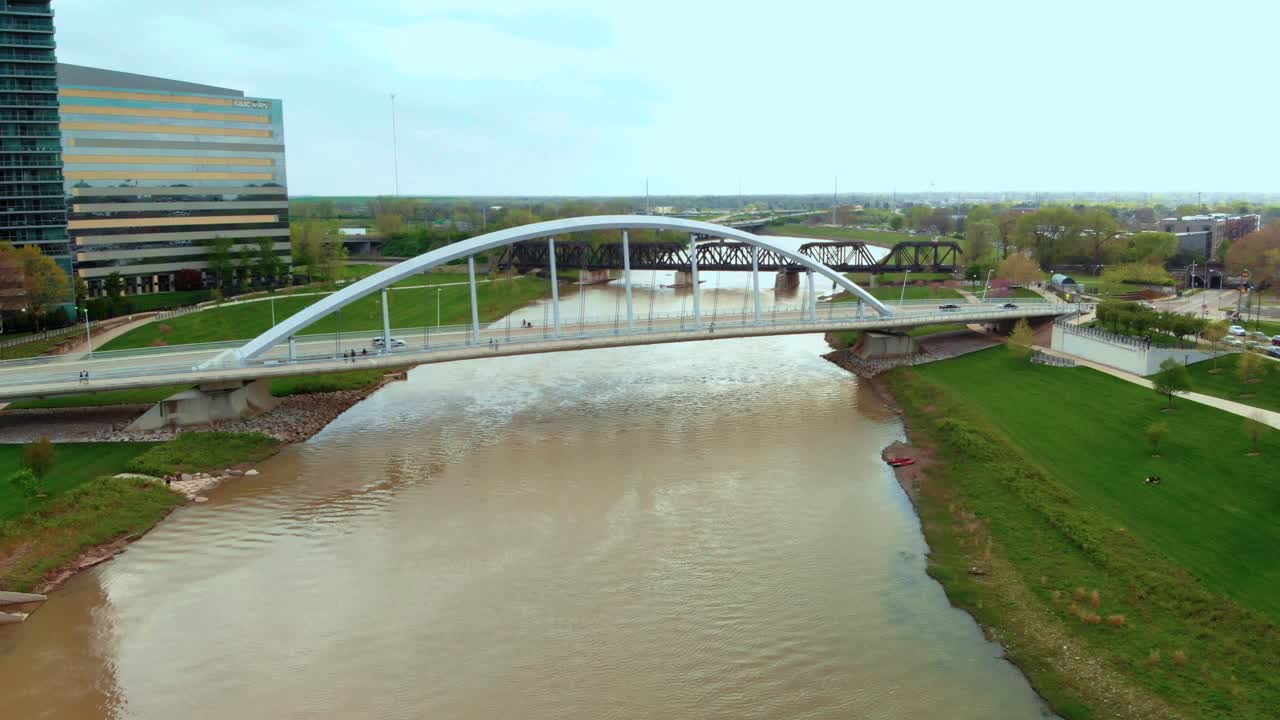 Aerial View of Modern Arch Bridge over River in City