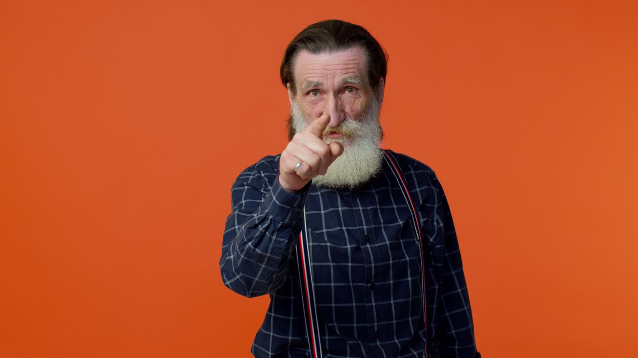 Mature old man smiling excitedly, pointing to camera, beauty choosing lucky winner, indicating you