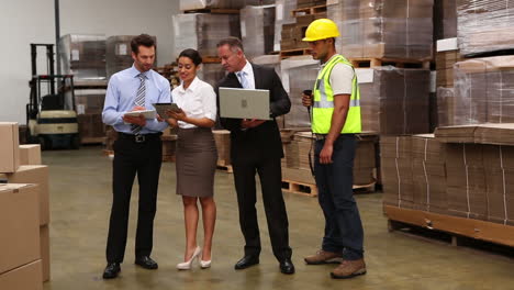 warehouse managers and worker talking