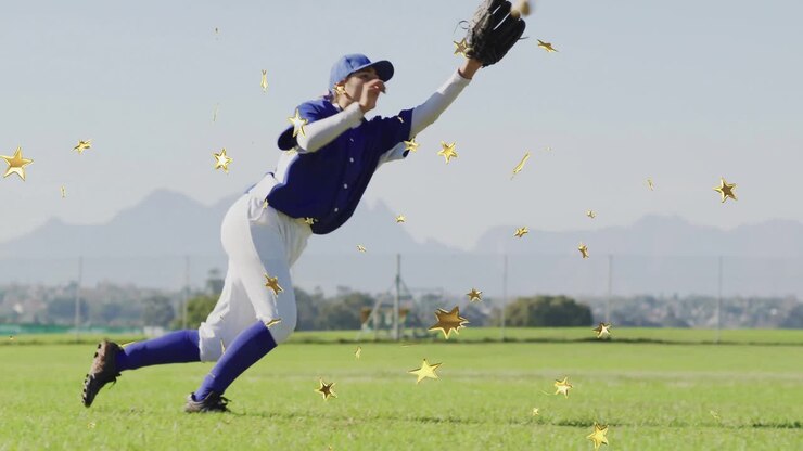 female baseball player diving on grass field for marketing, with gold star graphics floating