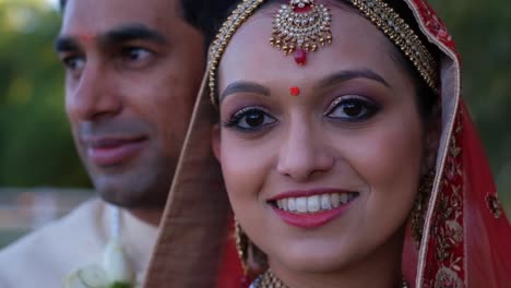 hindu wedding groom and bride looking at camera - close up