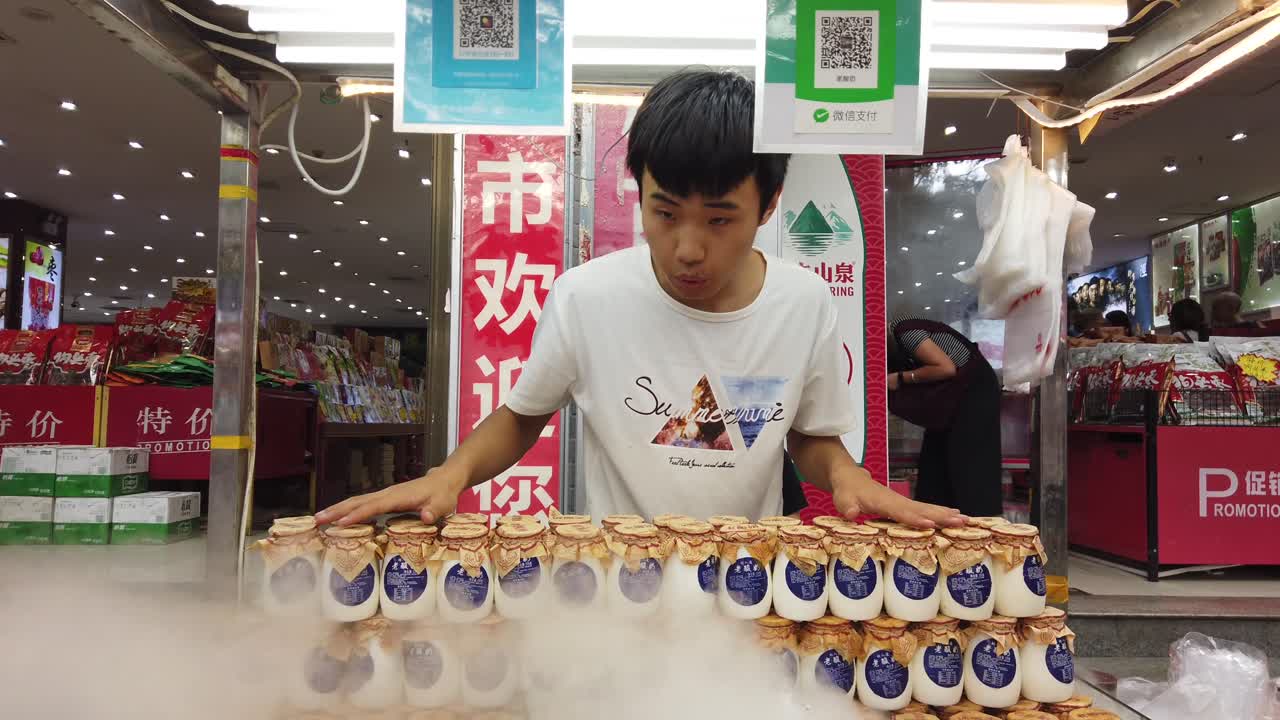 Xian, China - July 2019 : Freshly prepared chilled yoghurt for sale on a streetfood market in popular Muslim Quarter