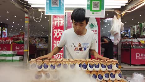 xian, china - july 2019 : freshly prepared chilled yoghurt for sale on a streetfood market in popular muslim quarter