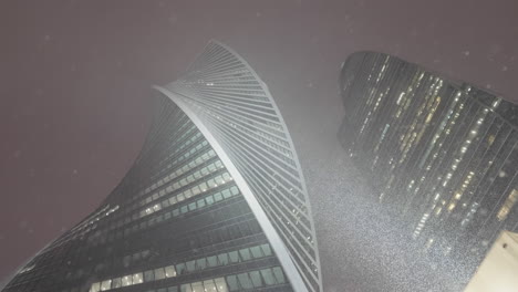 modern skyscrapers in a snowstorm at night