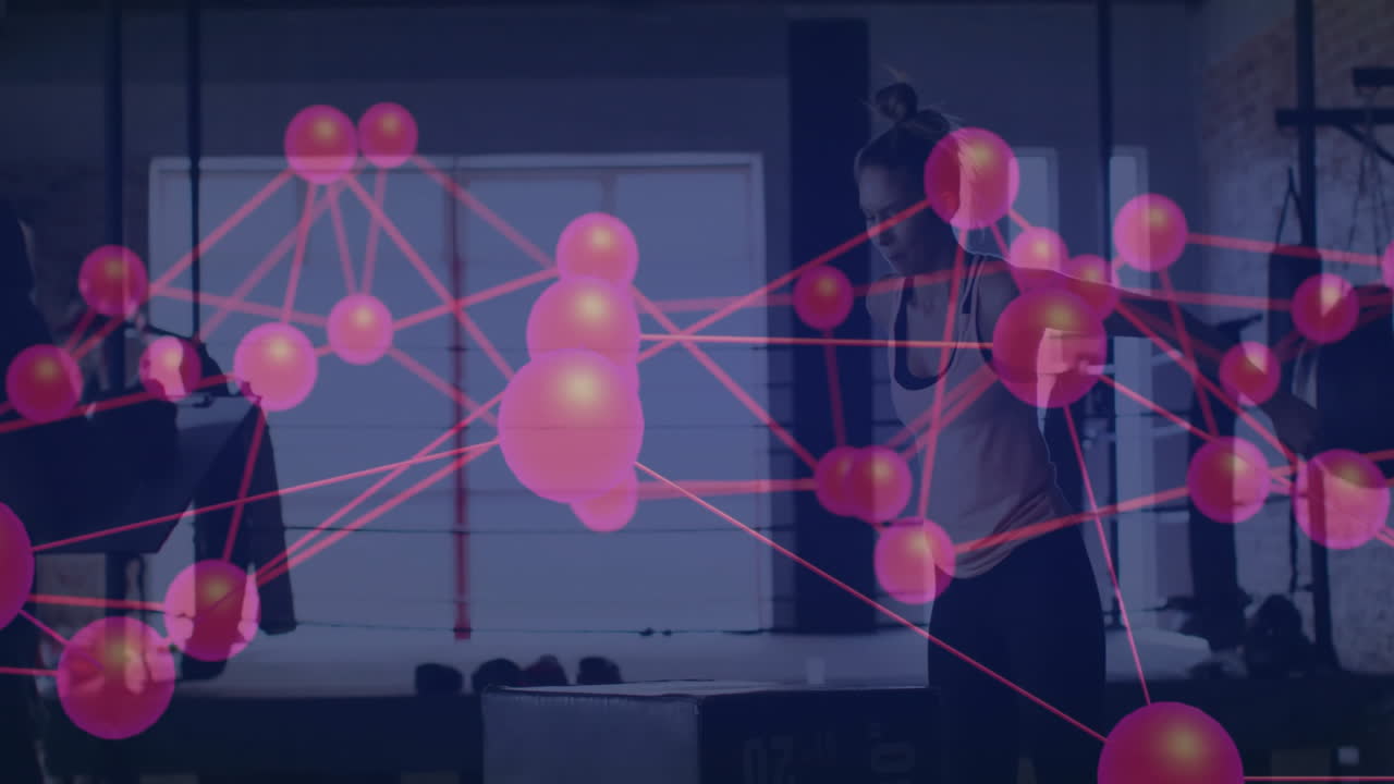 Workout partners adjusting dumbbells in fitness studio, with neon network nodes floating overhead
