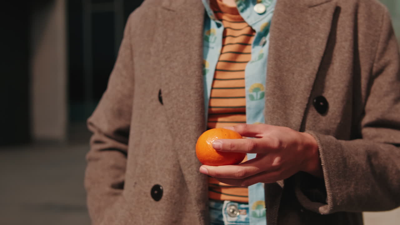 Woman Peeling a Tangerine Outdoors