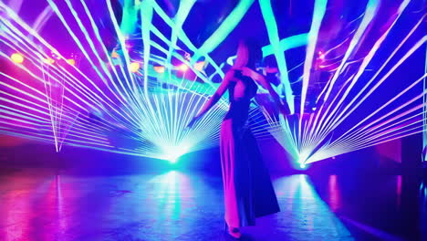 woman dancing amidst vibrant laser lights on stage