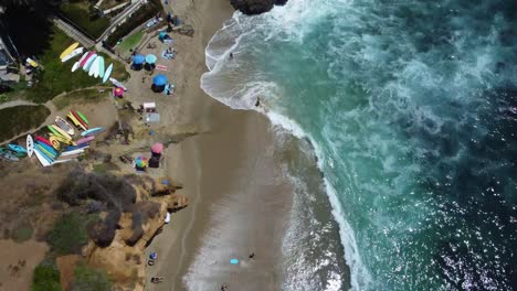 birds eye aerial view of laguna beach ca usa, cliffs, sand, ocean waves and waterfront buildings