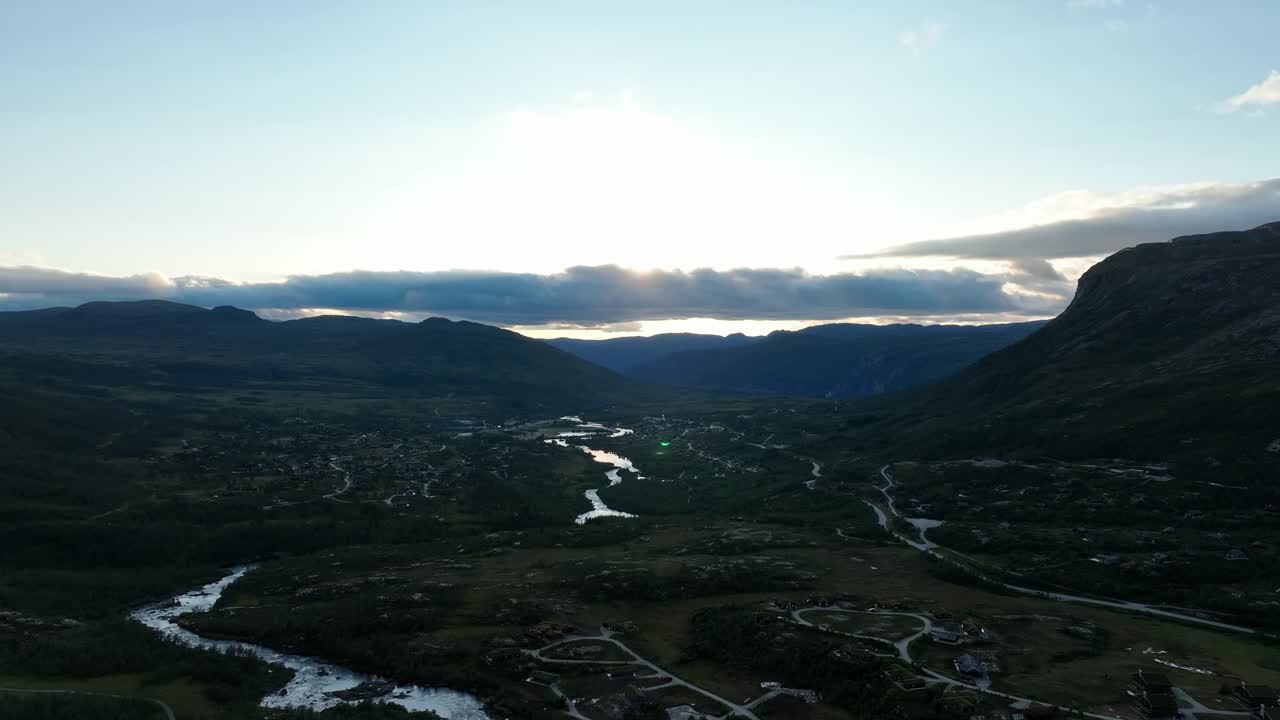 Maurset landscape towards Mabodalen in sunset with river, mountains, and cabins below