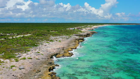 aerial panoramic of lush green cozumel island coastline with turquoise blue water in mexico on sunny summer day