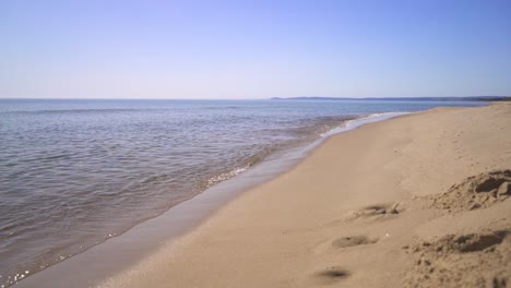 the waves calmly rolling in on a beach in europe