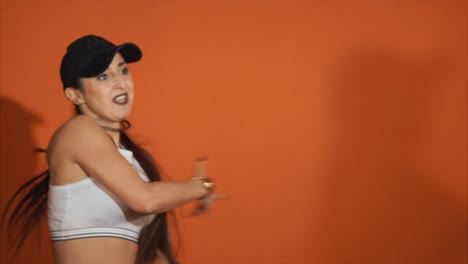 woman dancing in crop top and cap
