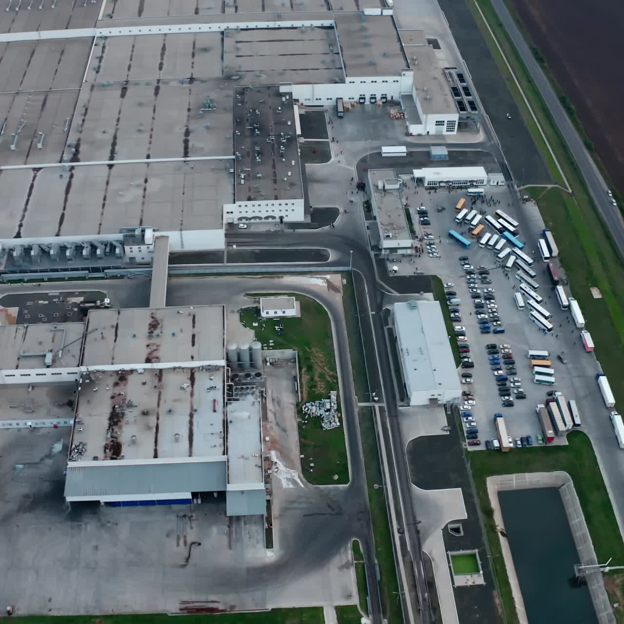 Harmful manufacturing among nature. Flight over the industrial area. Large territory of factory in the countryside. Aerial view.