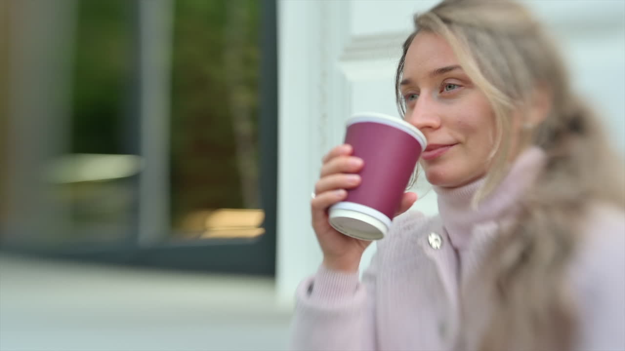 Brunette woman drinking coffee outside