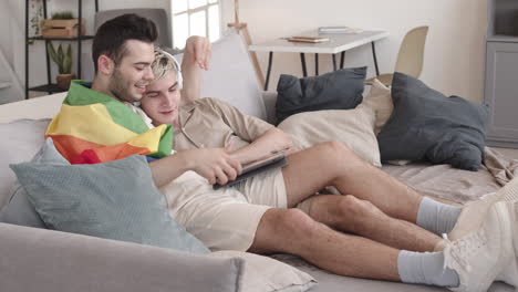 couple resting at home and using digital tablet