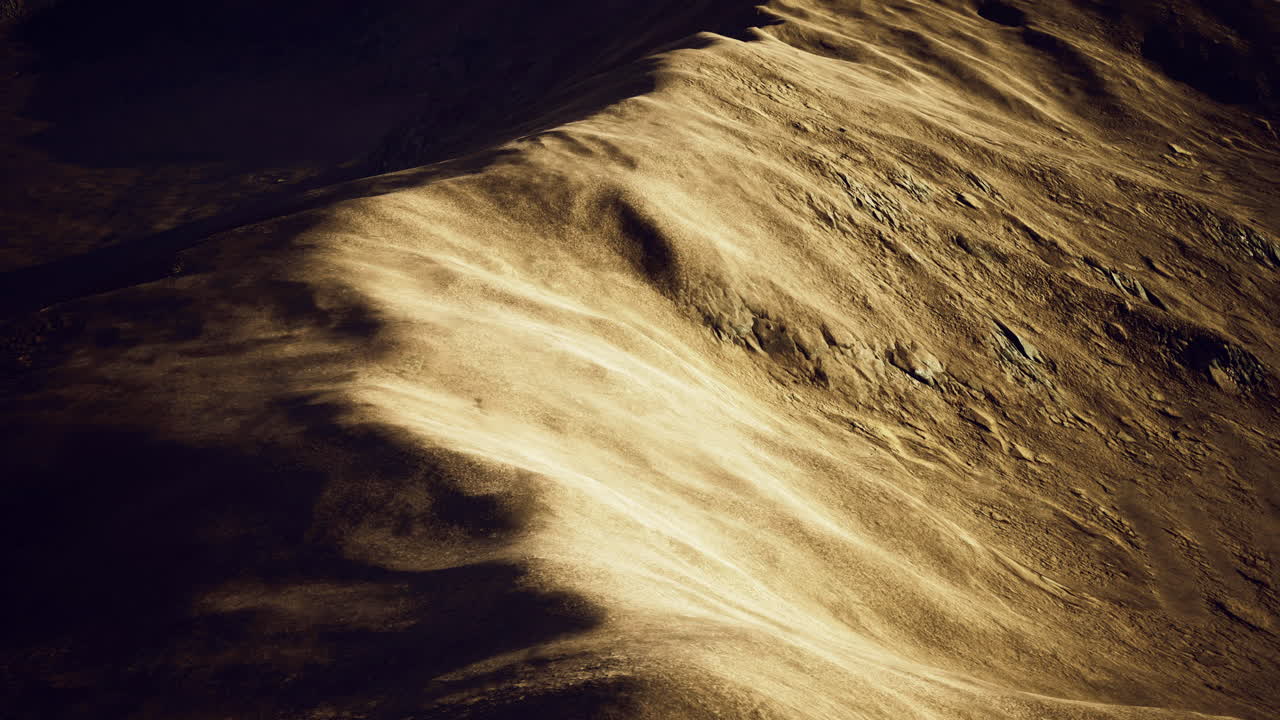 Golden sand dunes span a vast desert showcasing natural patterns
