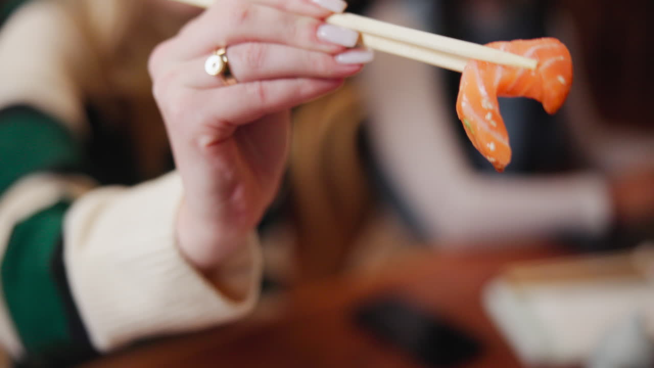 Eating sushi with chopsticks
