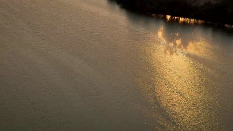 aerial shot of the sun rays at sunset reflected in the axotlan lagoon, north of mexico city
