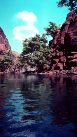 a beautiful canyon lake with red rocks and blue sky