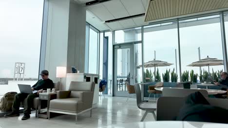 modern lounge with city view and people