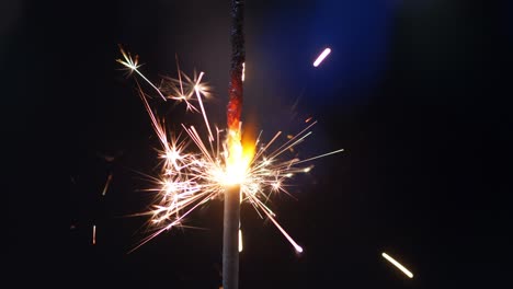 burning bengal fire and sparks on defocused background in 4k