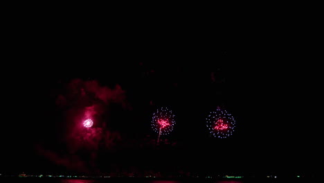 Three-big-explosions-up-high-and-then-in-the-bottom-consecutively,-Pattaya-international-Fireworks-Festival-2023,-Thailand