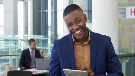 Young-businessman-using-tablet-in-a-modern-office