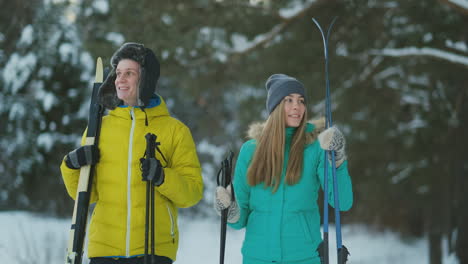 man and woman in love with ski equipment going to ski terrain