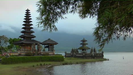 morning fog and mist surround the ulun danu temple in lake bratan bali indonesia