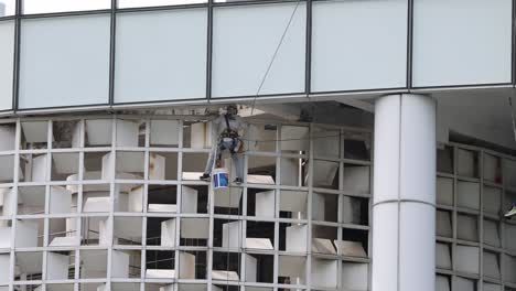 workers cleaning windows on a skyscraper.