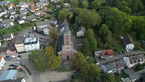 el dron vuela hacia atrás mientras la cámara mira hacia una iglesia en baden-baden, alemania, con el bosque negro a la vista.