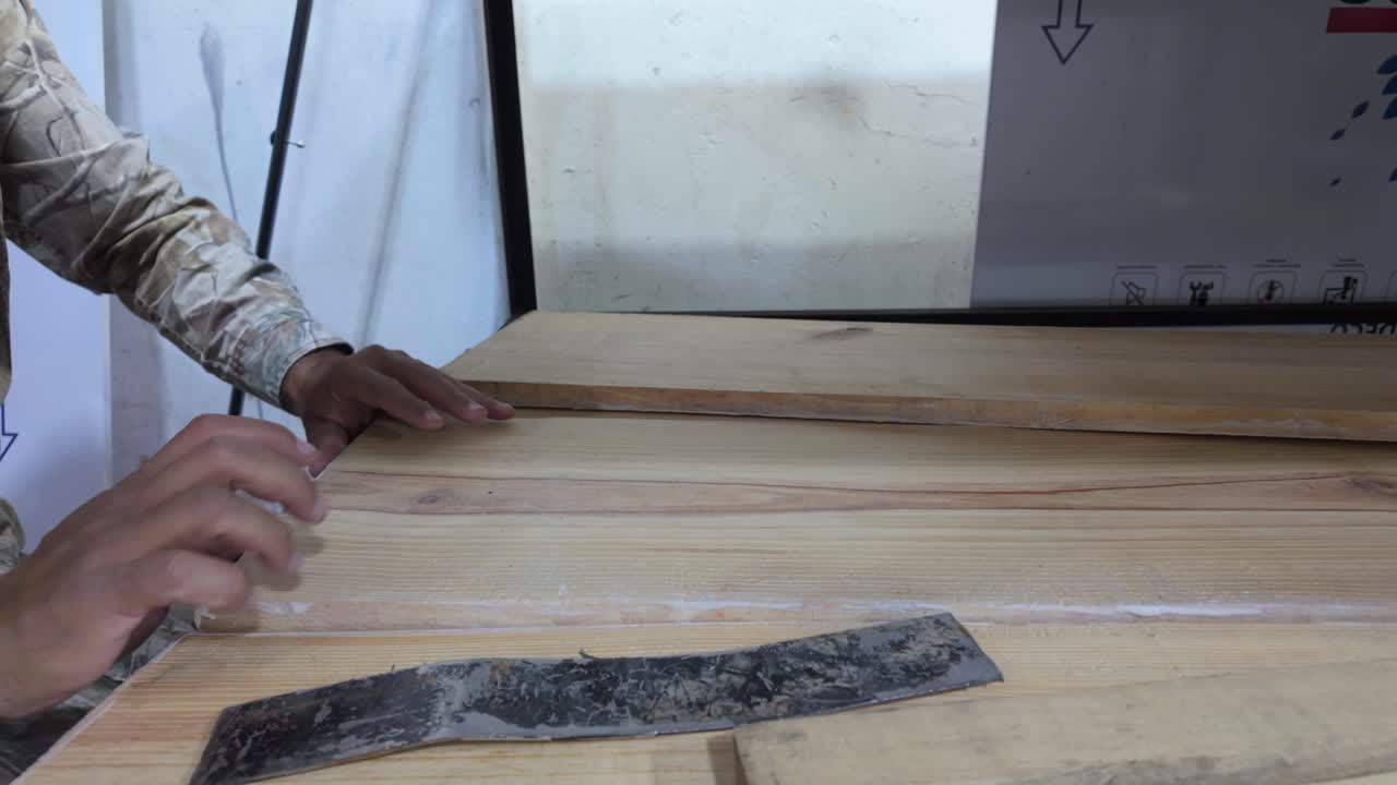 Capturing the precision and focused care of a skilled artisan as they craft a piece of furniture by hand in a rustic workshop