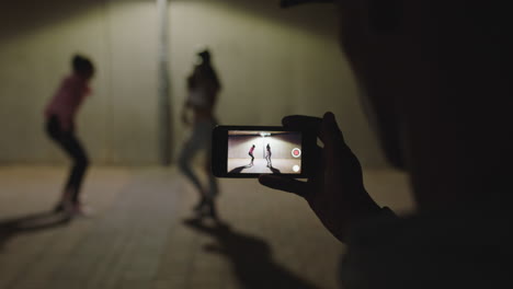 dancing woman happy hip hop dancer girls dance under street light friend using smartphone taking video enjoying sharing on social media in city at night